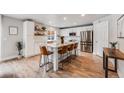 Modern kitchen with stainless steel appliances, a large island with seating, and lots of natural light at 2418 Coach House Loop, Castle Rock, CO 80109