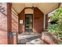 Inviting front porch with brick columns, a secure door, and a classic mailbox at 55 S Grant St, Denver, CO 80209