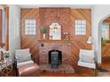 Cozy living room with brick fireplace, stylish decor, and wood floors for a warm atmosphere at 55 S Grant St, Denver, CO 80209