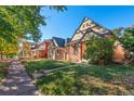 Neighborhood street showcasing charming homes with well-maintained lawns and mature trees at 55 S Grant St, Denver, CO 80209