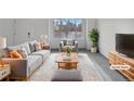 Virtually staged living room featuring modern furniture and a large window at 5599 W 115Th Ave, Westminster, CO 80020