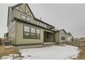 Landscaped backyard with a patio and partial snow cover at 1853 Hickory Ave, Erie, CO 80516