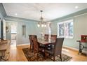 Elegant dining room with a wooden table, chandelier lighting, and natural light from the window at 2300 Jasmine St, Denver, CO 80207