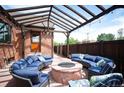 Outdoor patio area featuring comfortable seating around a stylish fire pit, perfect for entertaining at 2300 Jasmine St, Denver, CO 80207