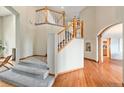 Inviting foyer with hardwood floors, staircase, and a view of the living spaces at 15846 W Bayaud Dr, Golden, CO 80401