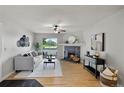 Bright living room featuring hardwood floors, fireplace, stylish furnishings, and balcony access at 13404 E Jewell Ave # 101, Aurora, CO 80012