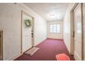 Inviting hallway leading to unit #11 with neutral walls, carpet, and a decorative wreath on the door at 1365 N Corona St # 11, Denver, CO 80218