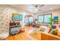Cozy living room with Zebra wallpaper, hardwood floors, a ceiling fan, and abundant natural light at 1365 N Corona St # 11, Denver, CO 80218
