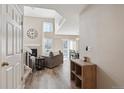 Bright entryway with wood floors, leading to living room at 8716 Starwood Ln, Parker, CO 80134