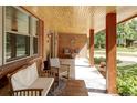 Inviting front porch with comfortable seating, wood ceiling and supporting posts with nice brick accents at 365 Seminole Dr, Boulder, CO 80303