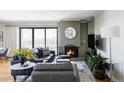 Inviting living room featuring a cozy fireplace, city views, and stylish contemporary decor at 460 S Marion Pkwy # 1701, Denver, CO 80209