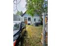 An outdoor space with mixed grass, paved walkway, storage shed, and parking at 4316 Josephine St, Denver, CO 80216