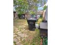 An outdoor space with mixed grass, paved walkway, storage shed, and parking at 4316 Josephine St, Denver, CO 80216