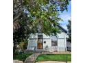 Charming home featuring unique architectural details, light grey brick, and a well-maintained front yard at 4316 Josephine St, Denver, CO 80216