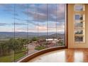 An impressive wall of windows offers stunning panoramic views in this home with hardwood floors and modern trim at 606 Cliffgate Ln, Castle Rock, CO 80108