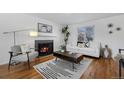 Cozy living room with hardwood floors, fireplace and comfortable seating at 1924 S Kearney Way, Denver, CO 80224