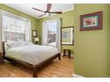 Tranquil bedroom bathed in natural light, featuring hardwood floors and a soothing green color scheme at 1301 N Ogden St # 1A, Denver, CO 80218