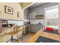 Efficient kitchen with gray cabinetry, stainless steel appliances, and a cozy breakfast nook next to the window at 1301 N Ogden St # 1A, Denver, CO 80218