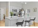 Modern kitchen with stainless steel appliances, marble countertops, and island with seating at 7240 W Custer Ave # 119, Lakewood, CO 80226
