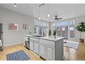Stylish kitchen island with stainless steel sink, dishwasher, and adjacent access to the outdoor deck at 7240 W Custer Ave # 119, Lakewood, CO 80226