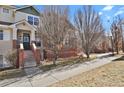 Charming front entrance showcasing a brick facade and a welcoming stairway to the front door at 1443 S Emporia Ct, Aurora, CO 80247