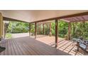 Spacious wooden deck with a pergola, perfect for outdoor entertaining and relaxing in a private backyard setting at 8292 E Lehigh Dr, Denver, CO 80237