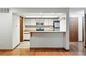 Functional kitchen with white cabinets, wood countertops, and modern appliances at 2960 Shadow Creek Dr # 201, Boulder, CO 80303