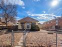 Lovely single-story home boasting a fenced front yard and a well-kept exterior under a bright, sunny sky at 1450 Joliet St, Aurora, CO 80010