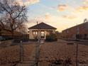 Quaint house with a fenced yard and walkway, capturing a cozy and inviting curb appeal at sunset at 1450 Joliet St, Aurora, CO 80010