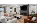 Contemporary living room with fireplace, plush seating, and stylish decor at 6429 Stable View St, Castle Pines, CO 80108