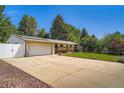 Charming single-story home featuring a spacious driveway and well-maintained lawn at 8075 Sunset Dr, Lakewood, CO 80214