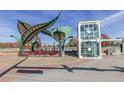 Exterior view of light rail station with elevator and leaf-shaped art installation on a sunny day at 1313 S Clarkson St # 205, Denver, CO 80210