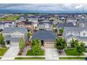 Aerial view of a well-planned neighborhood with single-Gathering homes, green spaces, and community amenities at 722 Eva Peak Dr, Erie, CO 80516