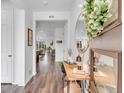 Inviting entryway features wood floors, stylish decor, and a view into the home's open living spaces at 722 Eva Peak Dr, Erie, CO 80516