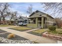 A charming bungalow with a welcoming front porch, complemented by beautifully landscaped surroundings at 4017 King St, Denver, CO 80211