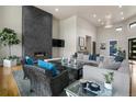 Inviting living room featuring a stylish fireplace, comfortable seating, and abundant natural light at 843 Long Timber Ln, Monument, CO 80132