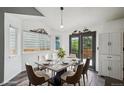 Dining room features an elegant table set with seating for six, modern decor, and bright natural light at 68 N Quicksilver Ave, Castle Rock, CO 80104