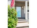 Inviting entryway features a vibrant blue door and clear house number signage at 186 S 45Th Ave, Brighton, CO 80601