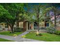 Well-kept front yard featuring a home with stone accents and a welcoming front porch at 12951 Vallejo Cir, Denver, CO 80234