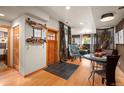 Inviting entryway showcases a wood door, decorative skateboards, and seamless flow to the living area at 469 Elati St, Denver, CO 80204