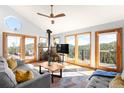 Cozy living room with a stone fireplace, hardwood floors and amazing views at 10180 Blue Sky Trl, Conifer, CO 80433