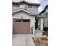 Townhome with a attached garage and neutral siding at 1078 Oak Cir, Denver, CO 80215