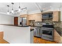 Modern kitchen with stainless steel appliances, granite countertops, and stylish backsplash, open to the living area at 2533 E 11Th Ave # 1, Denver, CO 80206