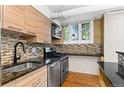 Modern kitchen featuring stainless steel appliances and tile backsplash at 2533 E 11Th Ave # 1, Denver, CO 80206