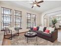 Bright living room with hardwood floors, large windows with blinds, and cozy seating arrangement at 5723 S Union Ct, Littleton, CO 80127