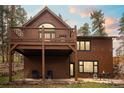 Stunning home exterior with a second-story deck overlooking the landscaped yard at 27711 Moffat Rd, Evergreen, CO 80439
