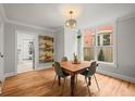 Dining room featuring hardwood floors, a square wood table with seating for four, and a large window at 2336 N High St, Denver, CO 80205