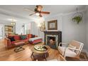 Cozy living room features a fireplace, ceiling fan, hardwood floors, and a comfortable seating area at 2336 N High St, Denver, CO 80205