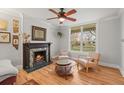 Living room featuring a fireplace, hardwood floors, and natural light from a large window at 2336 N High St, Denver, CO 80205