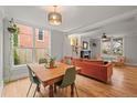 Open-concept living space with hardwood floors, dining area, and a cozy living room at 2336 N High St, Denver, CO 80205